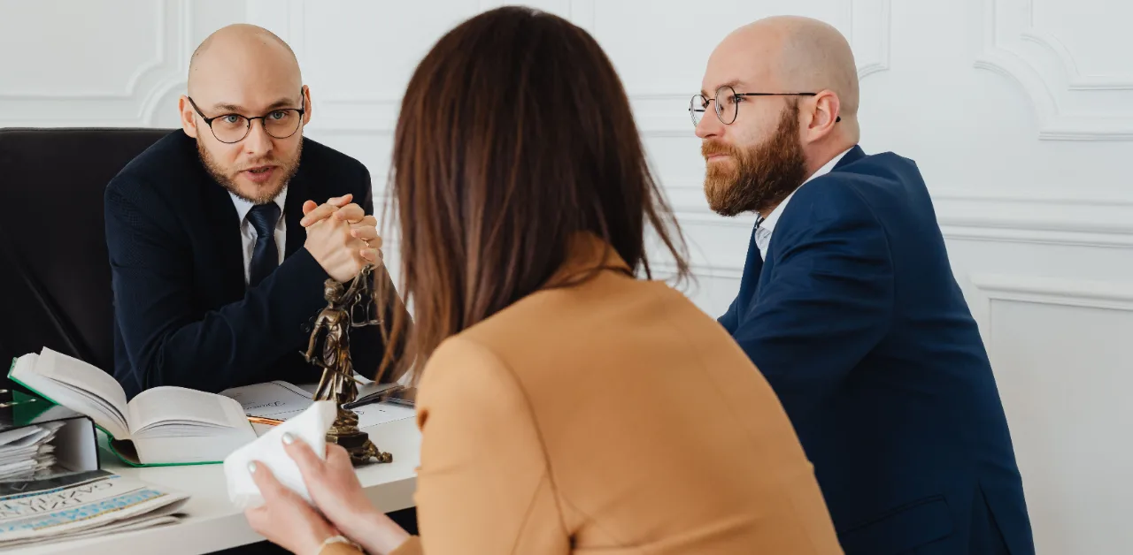 Attorney consulting with clients in a law office, representing legal SEO strategy for law firms
